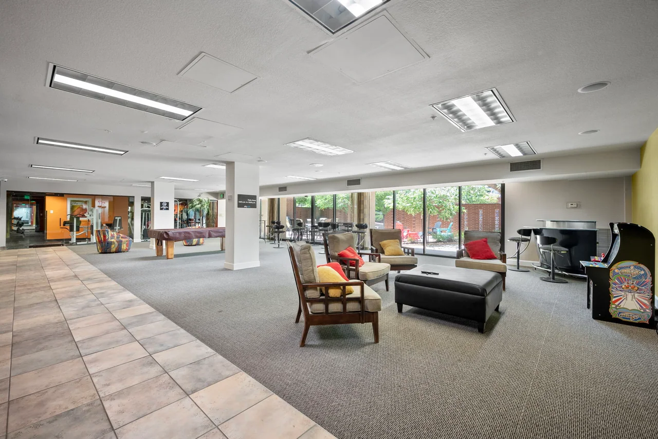 Citywalk shared game room with a pool table and patio beyond