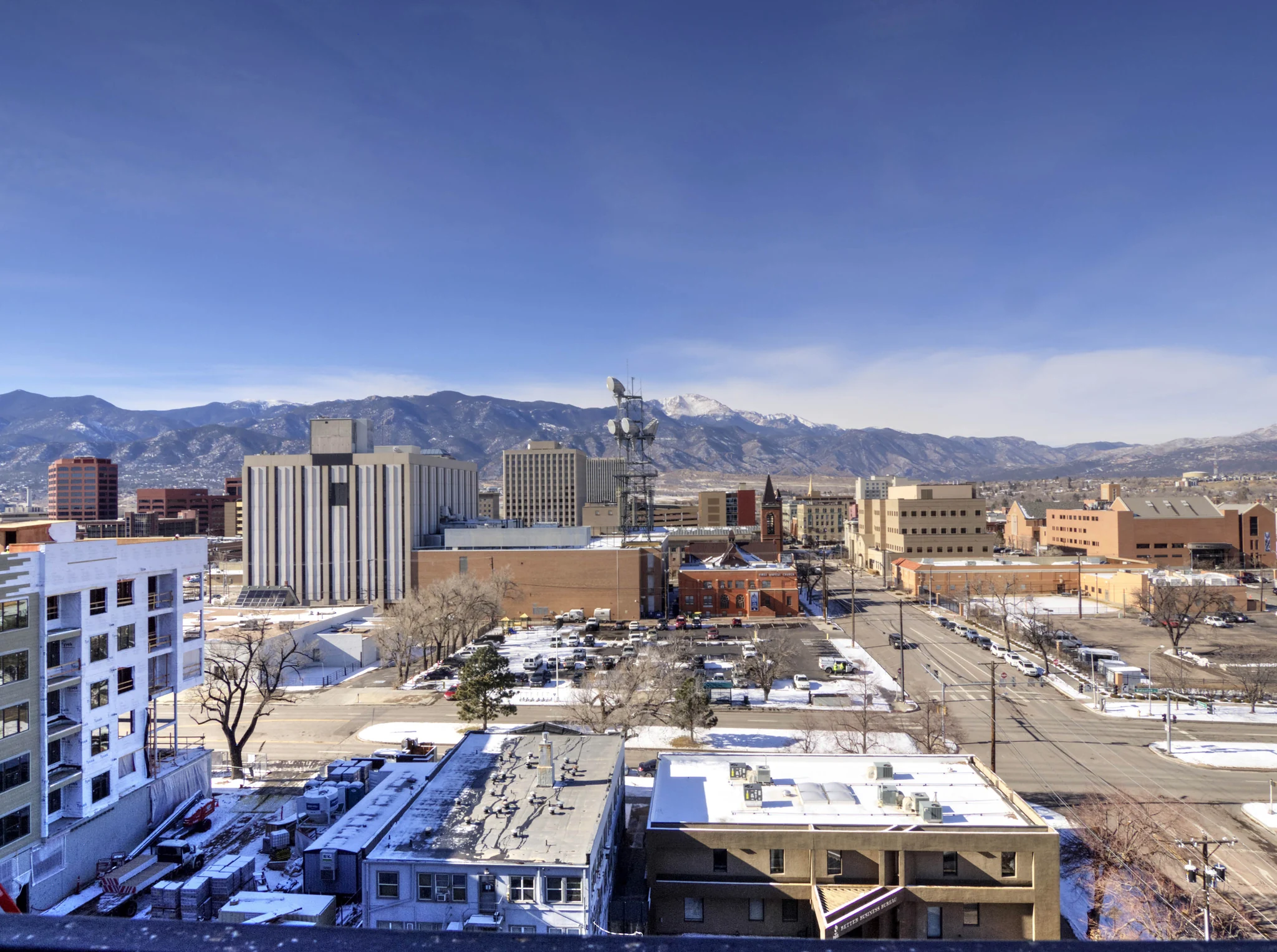 Downtown Colorado Springs streets and the Front Range seen from Citywalk in winter